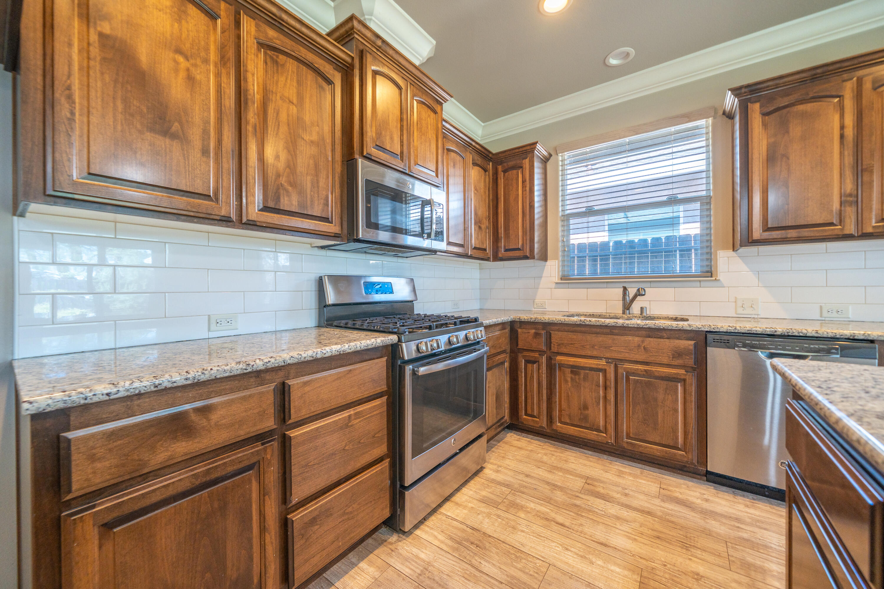 5571 Muir Peak Road Redding, CA 96002 - Photo 17 of 42 a kitchen with stainless steel appliances granite countertop a sink and cabinets