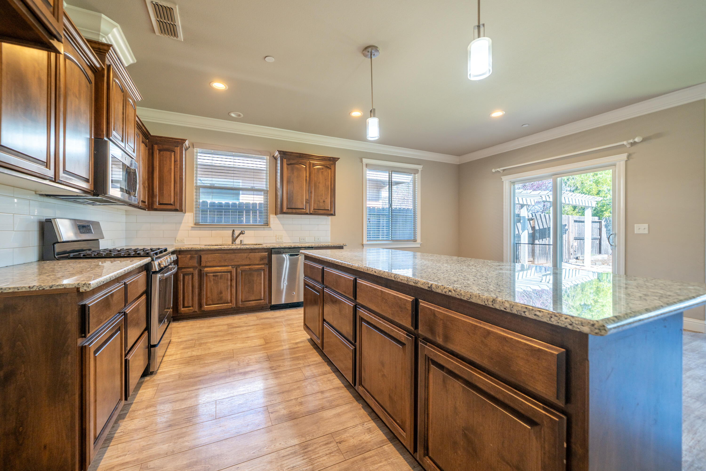5571 Muir Peak Road Redding, CA 96002 - Photo 18 of 42 a large kitchen with stainless steel appliances granite countertop a lot of counter space and a sink