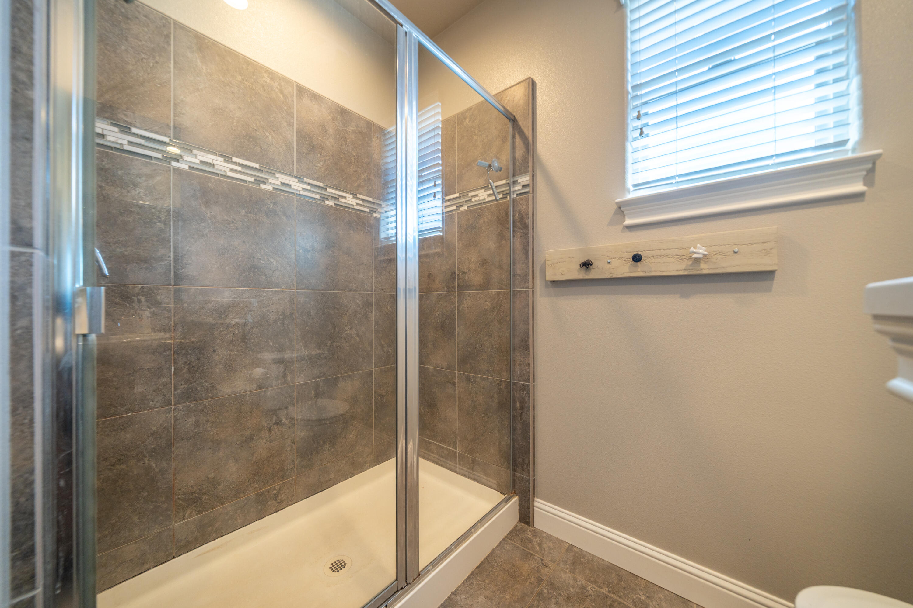 5571 Muir Peak Road Redding, CA 96002 - Photo 25 of 42 a bathroom with a bathtub and a shower