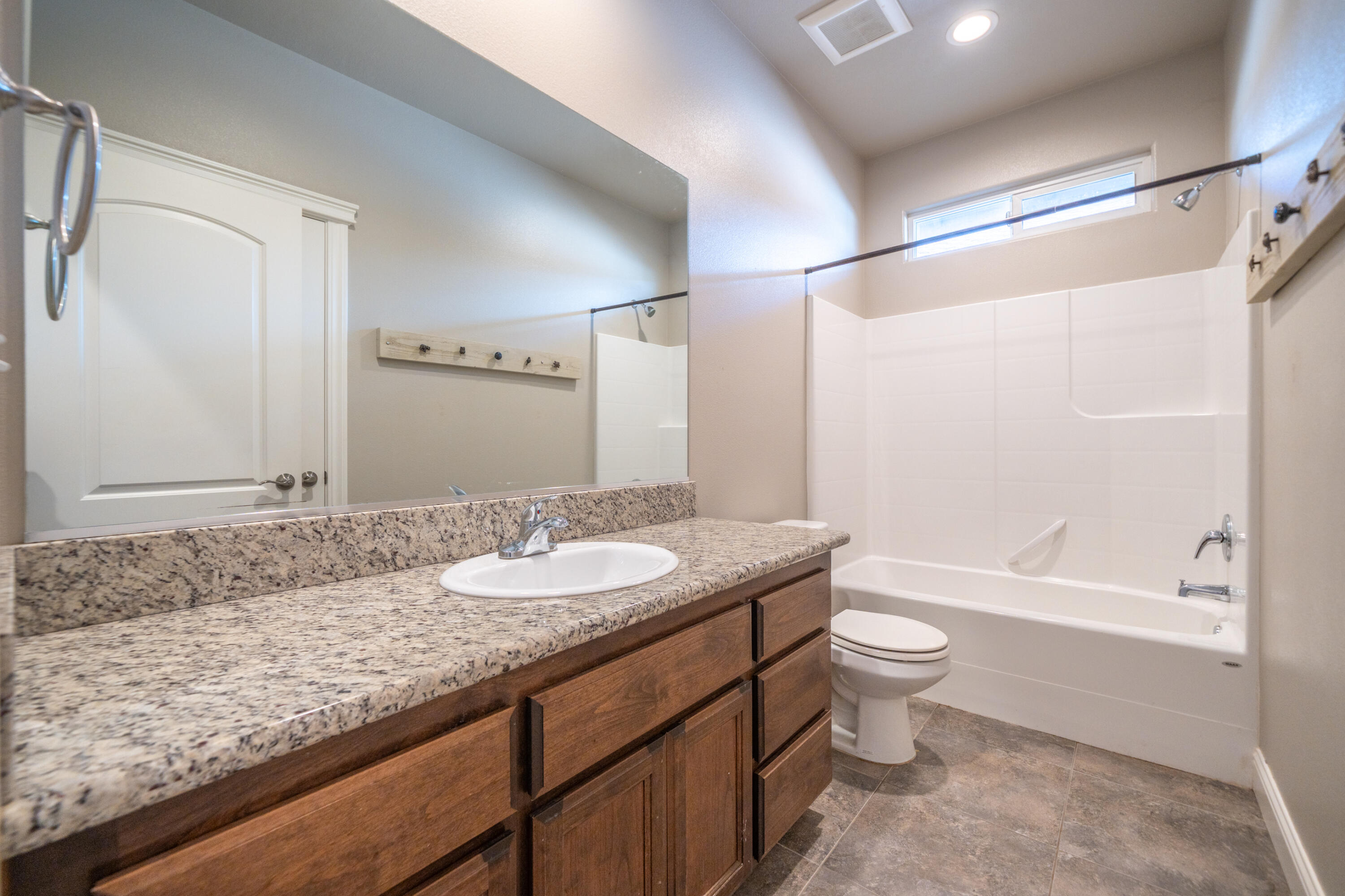 5571 Muir Peak Road Redding, CA 96002 - Photo 28 of 42 a bathroom with a granite countertop sink toilet and shower