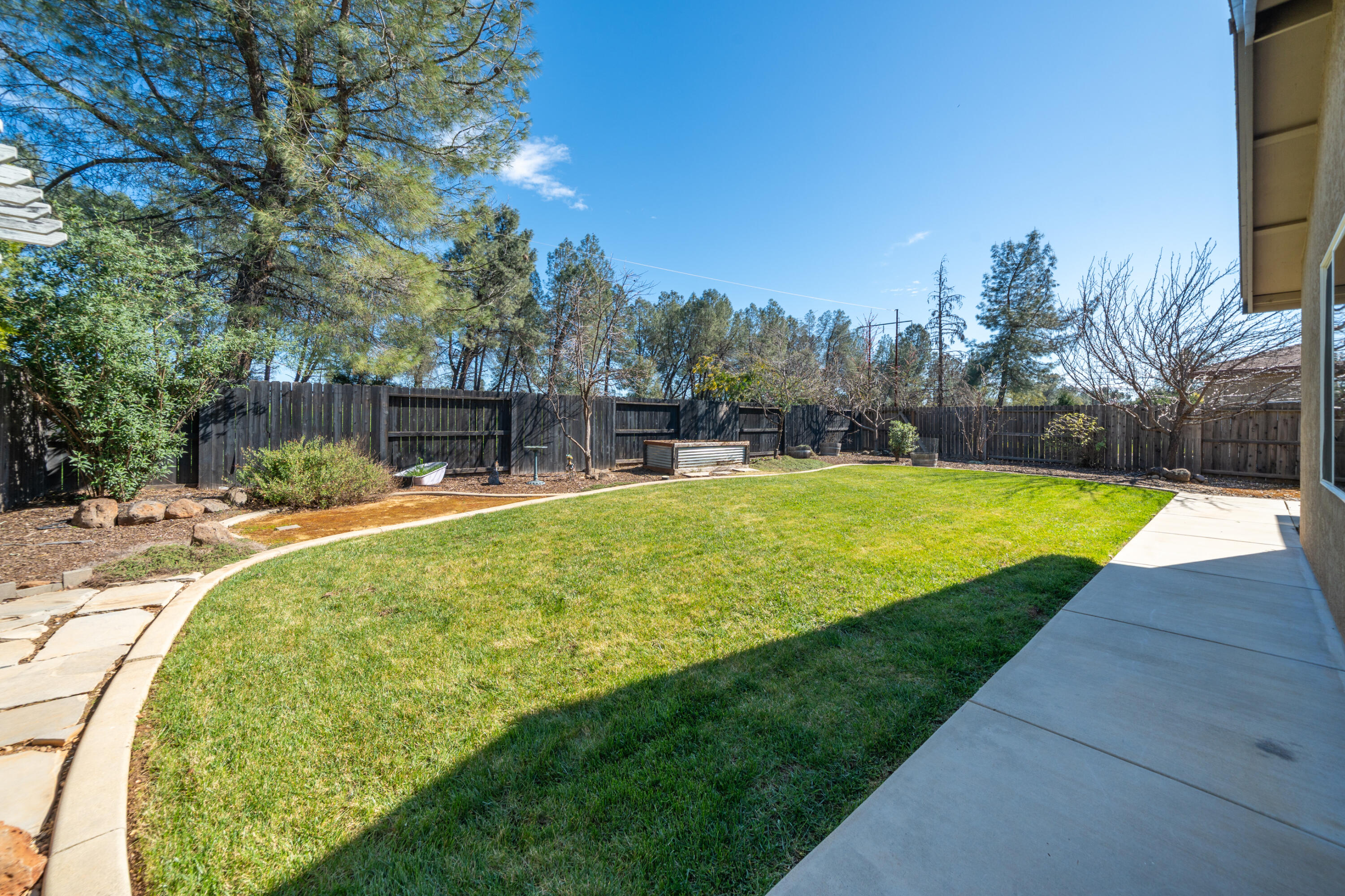 5571 Muir Peak Road Redding, CA 96002 - Photo 36 of 42 a swimming pool with outdoor seating and yard