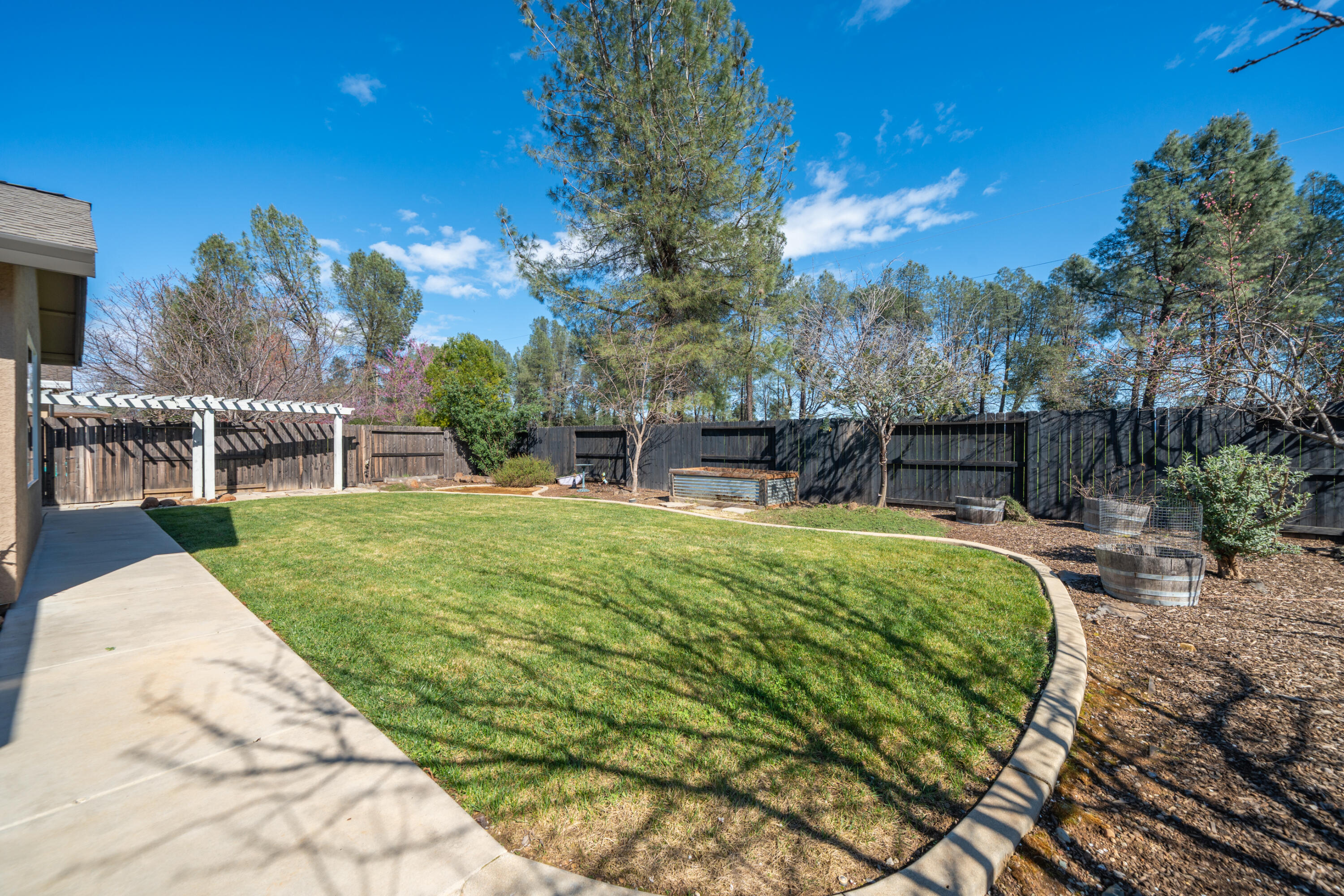 5571 Muir Peak Road Redding, CA 96002 - Photo 37 of 42 a view of a swimming pool with sitting area