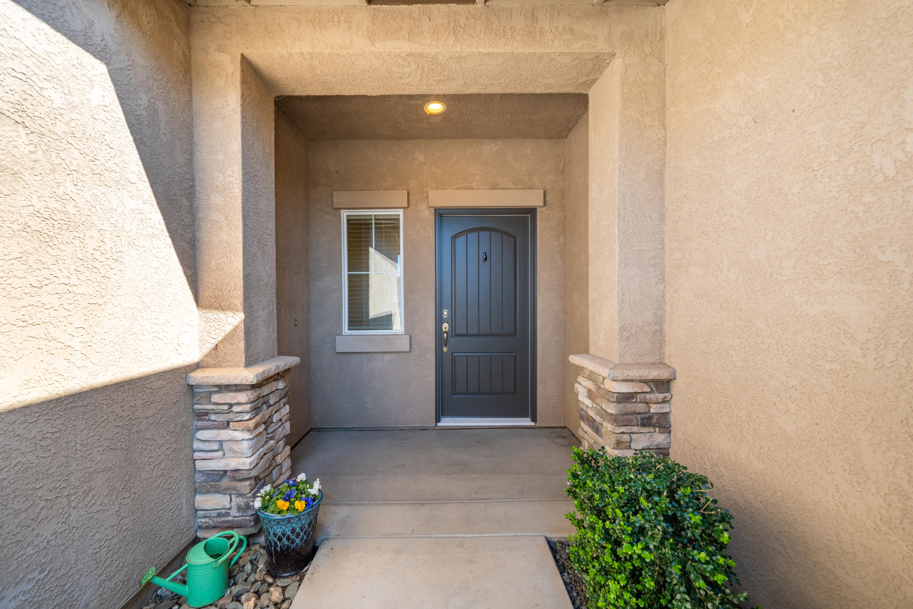 5571 Muir Peak Road Redding, CA 96002 - Photo 8 of 42 a front view of a house with potted plants