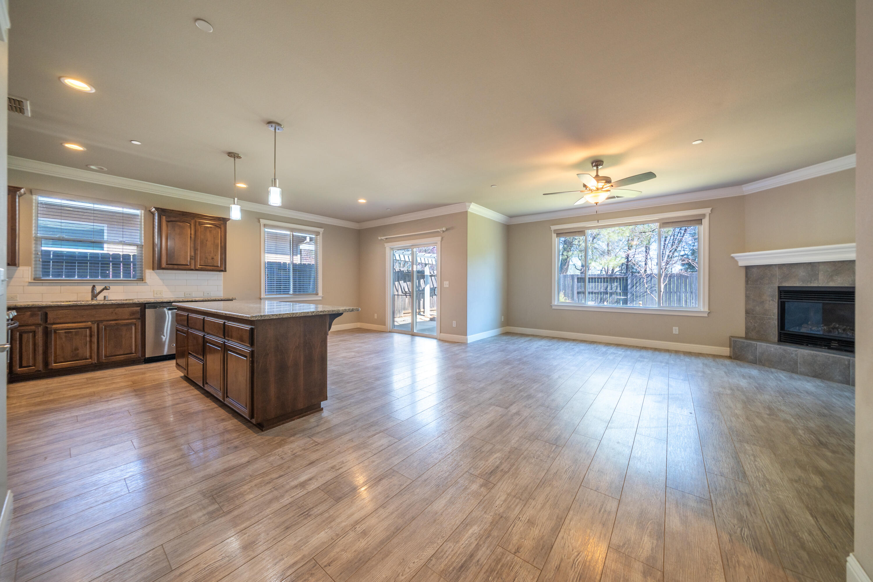5571 Muir Peak Road Redding, CA 96002 - Photo 10 of 42 a large kitchen with stainless steel appliances granite countertop a large counter top a wooden floors and a large window