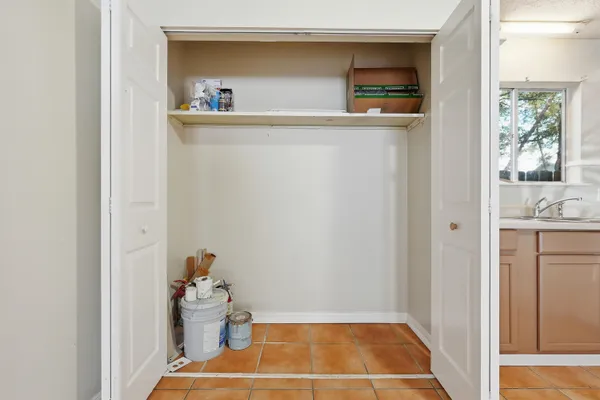 a kitchen with a cabinets and white appliances