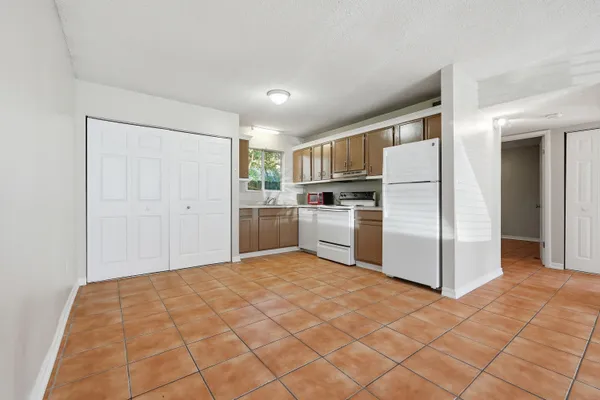 a kitchen with a refrigerator sink stove and cabinets