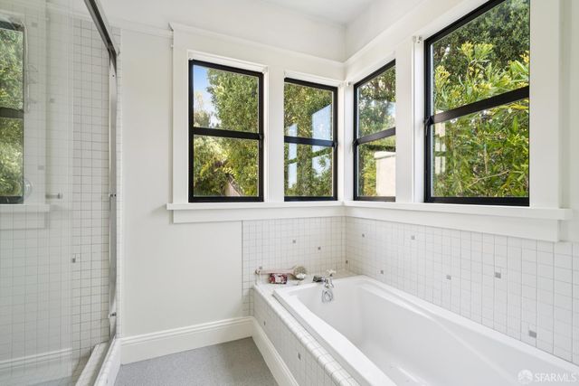 a bathroom with a bathtub and windows