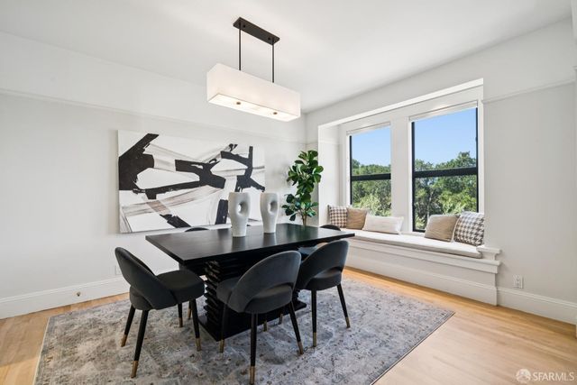 a view of a dining room with furniture wooden floor and chandelier