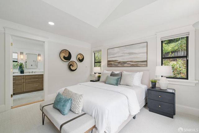 a bedroom with a bed and a painting on the wall