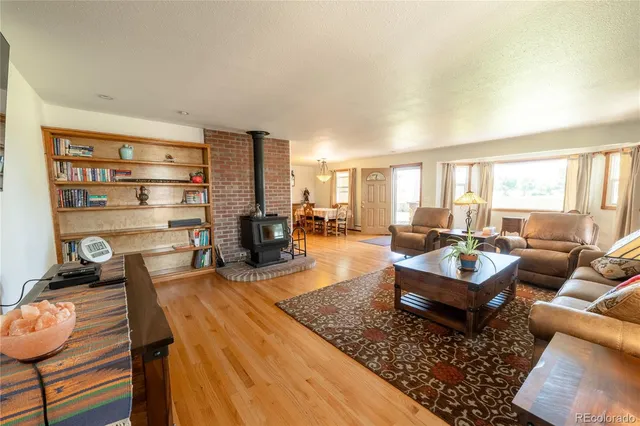 a living room with furniture fireplace and a large window