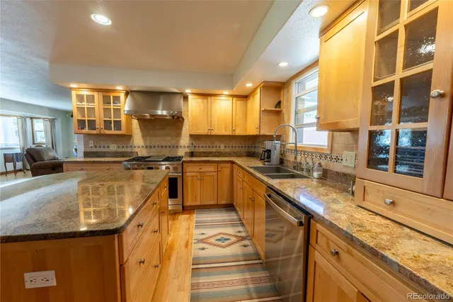 a kitchen with counter top space a sink and appliances