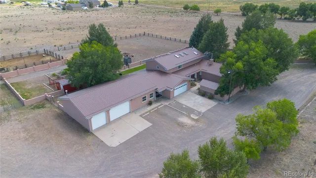 an aerial view of a house with a yard and a garage