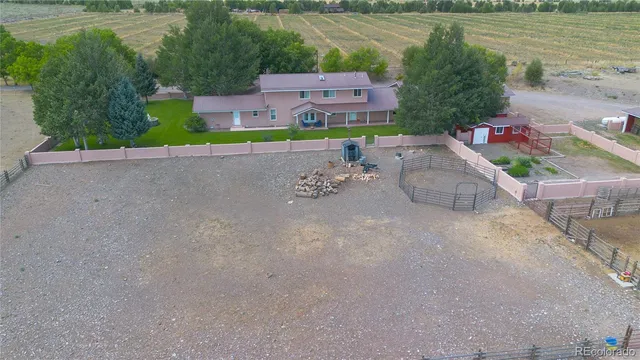 an aerial view of a house with a yard and a fountain