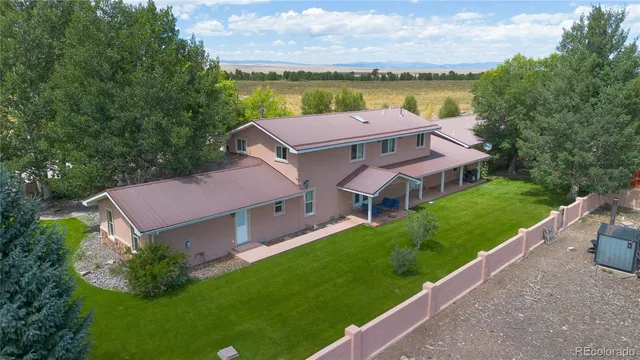a aerial view of a house with a garden and lake view