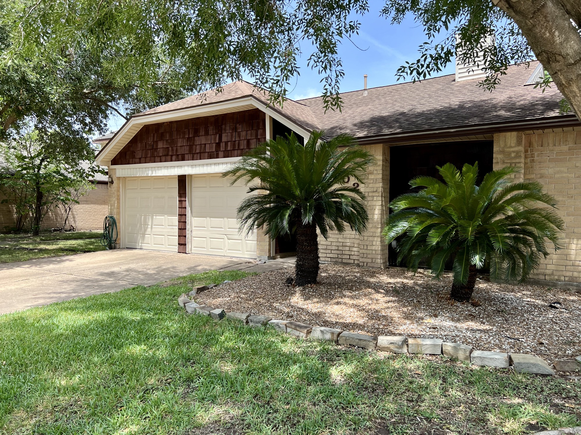 a front view of house with yard and trees