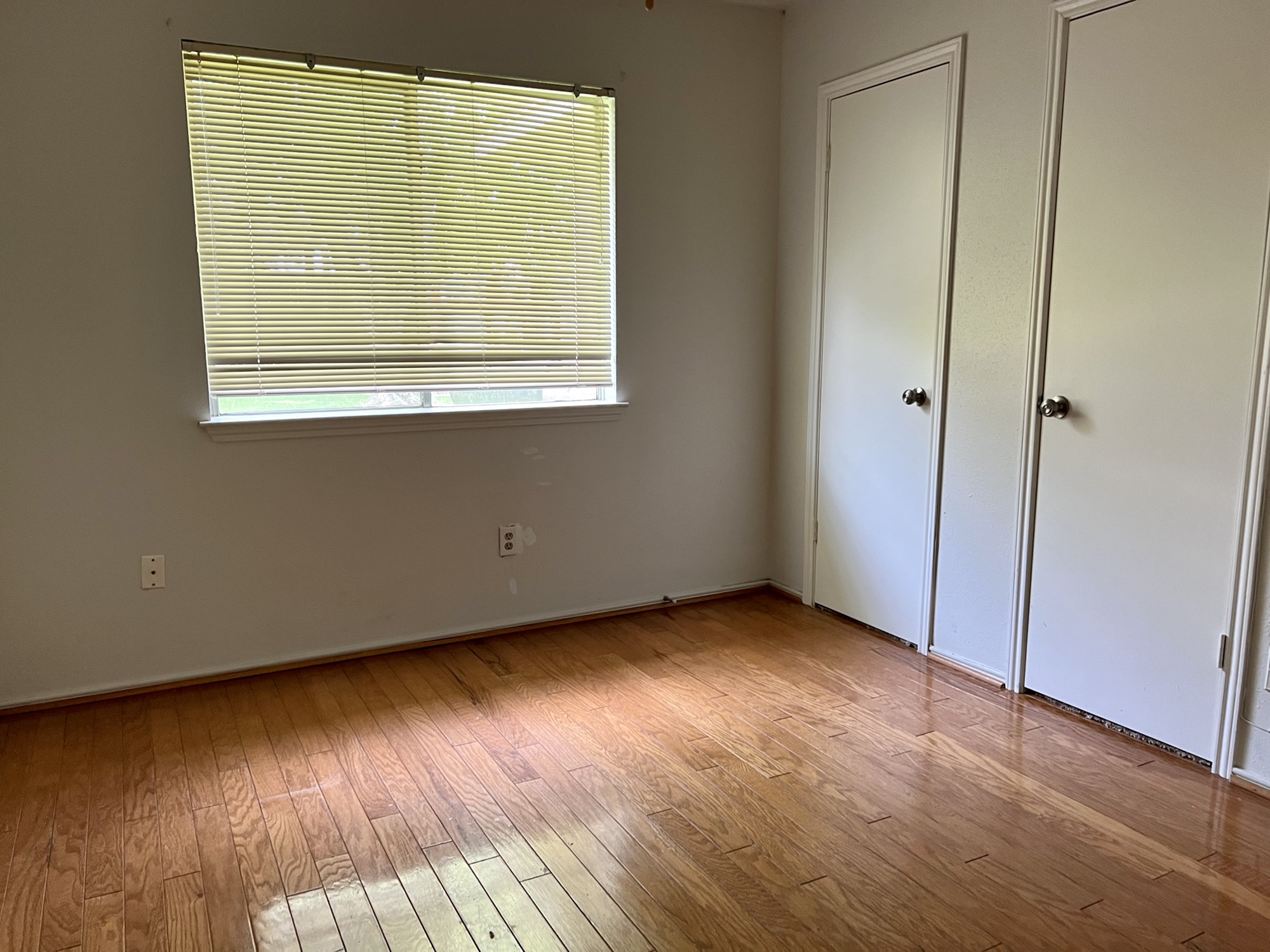 3702 Echo Grove Lane Houston, TX 77043 - Photo 11 of 18 an empty room with wooden floor and windows