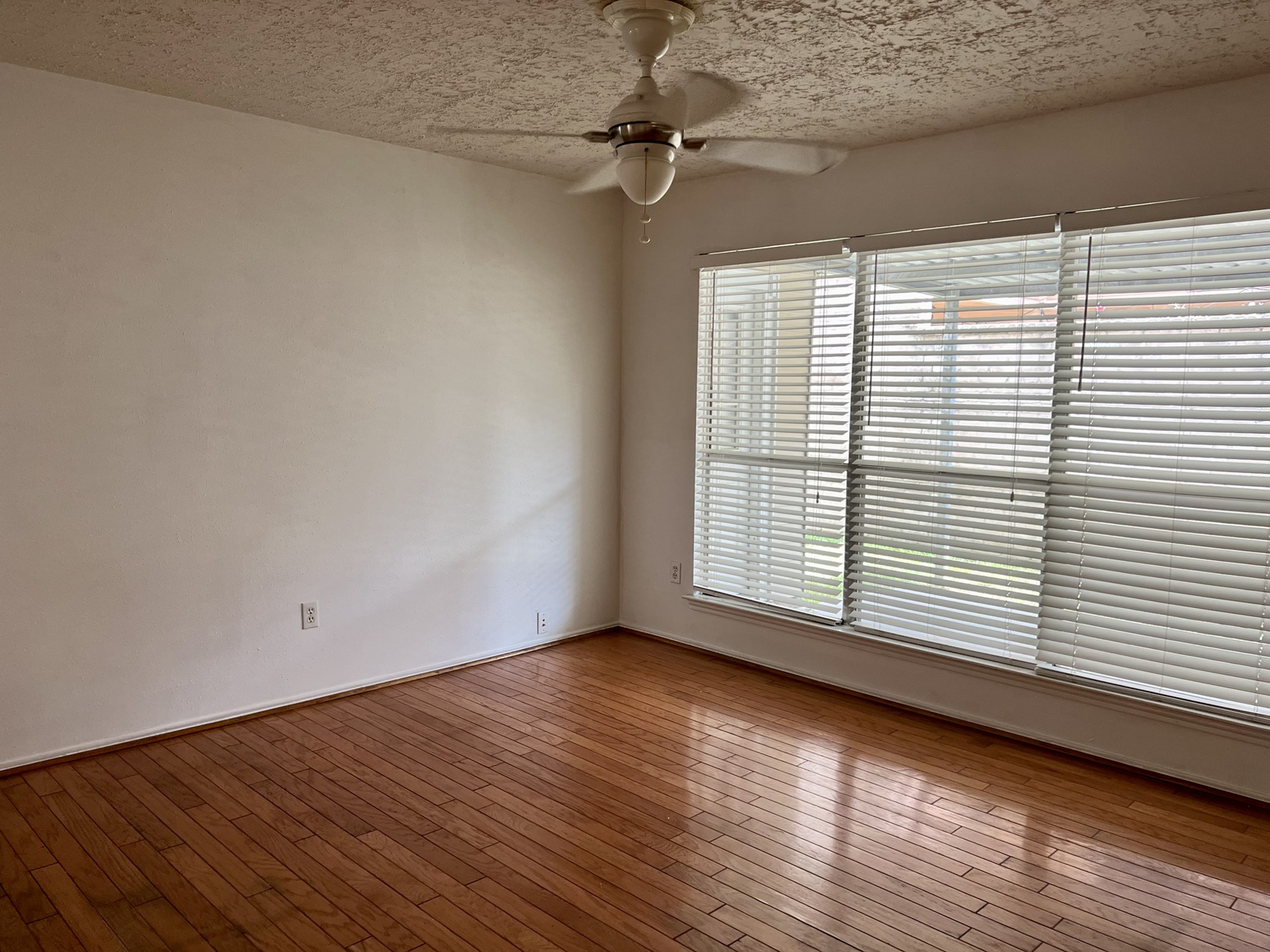 3702 Echo Grove Lane Houston, TX 77043 - Photo 8 of 18 wooden floor in an empty room with a window
