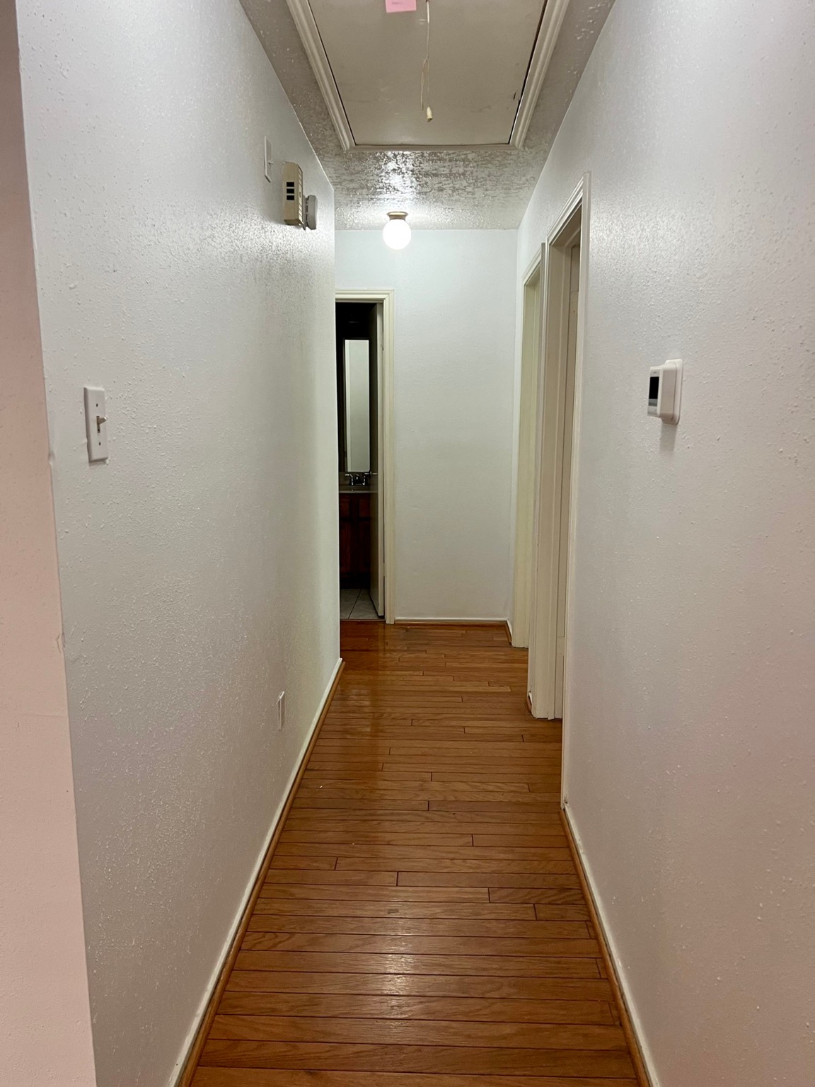3702 Echo Grove Lane Houston, TX 77043 - Photo 10 of 18 a view of a hallway with wooden floor