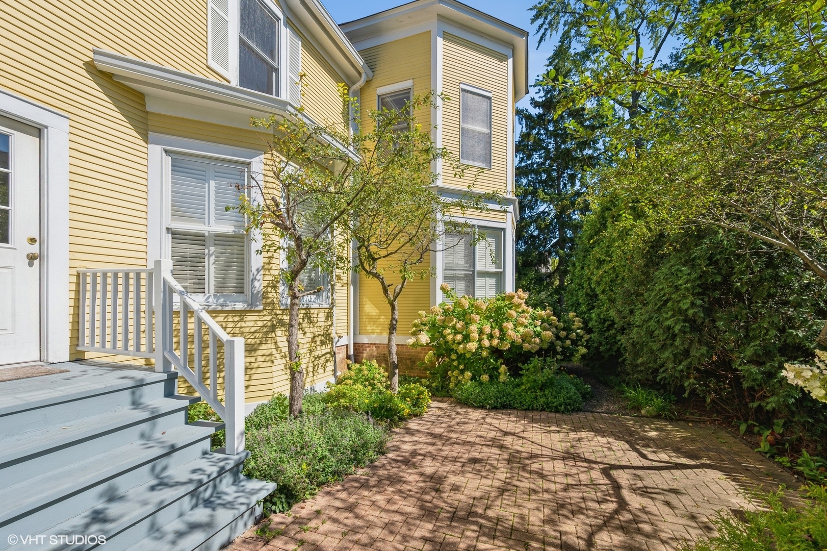 189 Ridge Avenue Winnetka, IL 60093 - Photo 3 of 4 a view of a brick house with plants and large tree