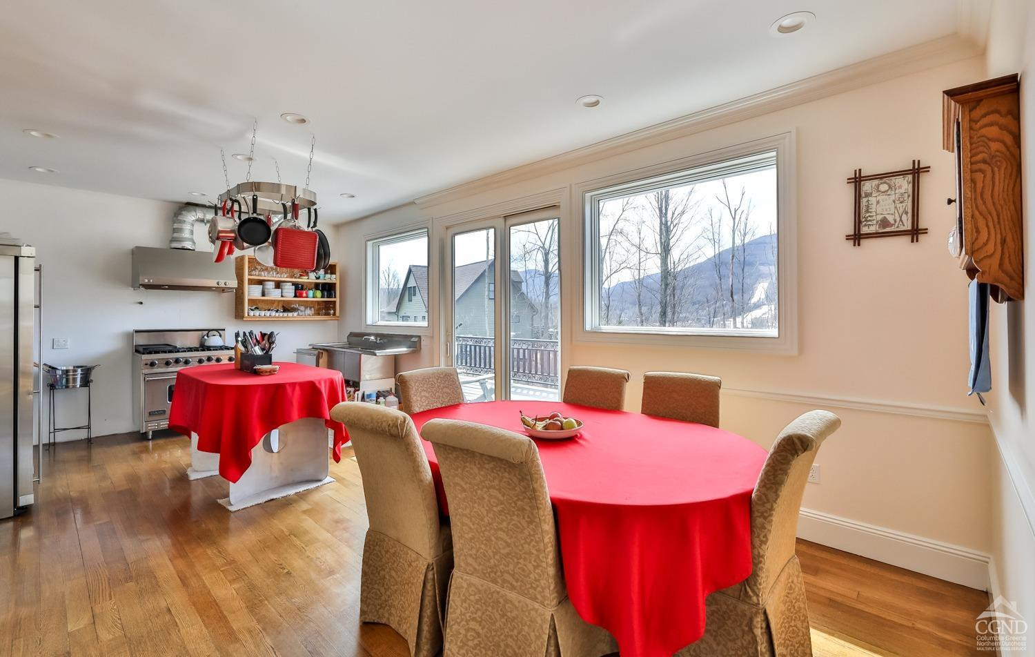 88 Gaby Road Hunter, NY 12442 - Photo 11 of 60 a view of a dining room with furniture a chandelier and a window