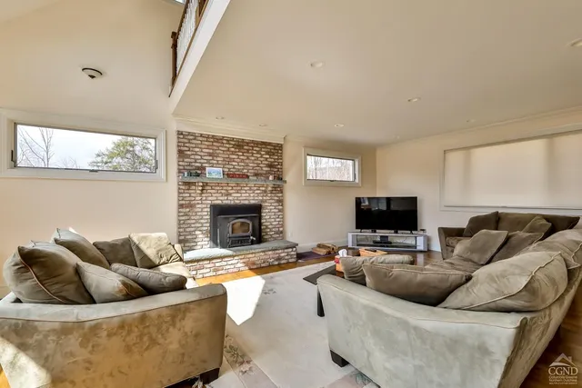 a living room with furniture fireplace and a table