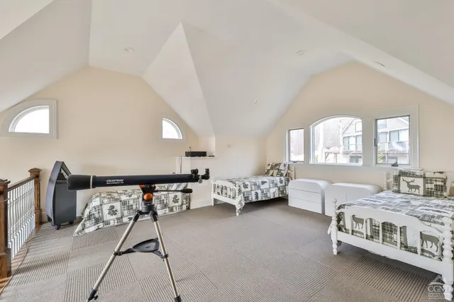 a bedroom with two beds and a window