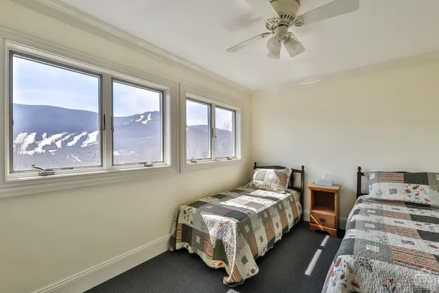 a living room with furniture and a dining table with wooden floor