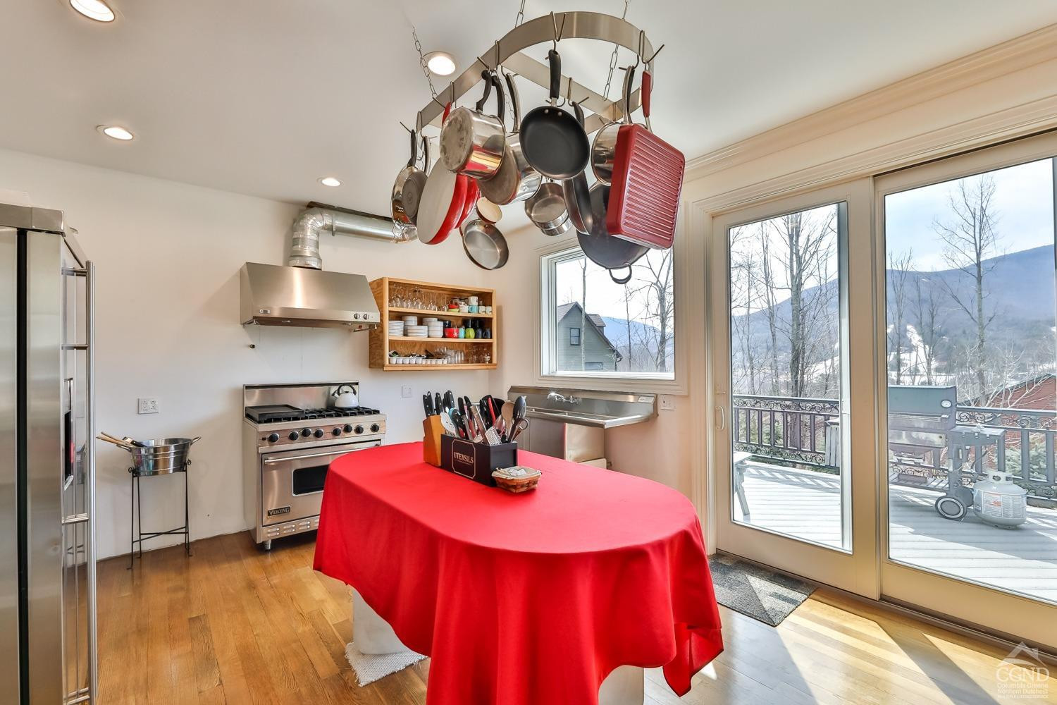 88 Gaby Road Hunter, NY 12442 - Photo 9 of 60 a kitchen with stainless steel appliances granite countertop a stove a refrigerator and a dining table with wooden floor