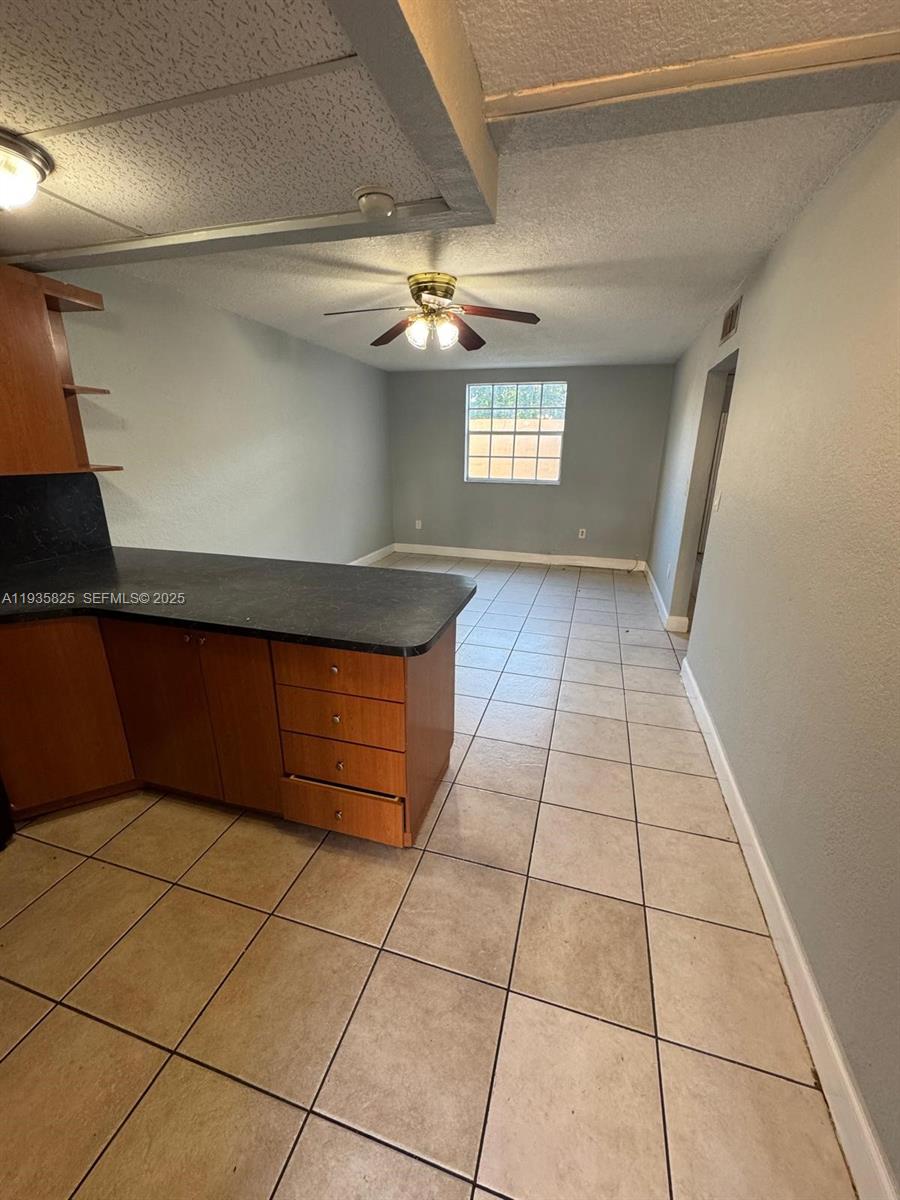 652 Northwest 3rd Street, Unit 104 Miami, FL 33128 - Photo 15 of 15 a view of a livingroom with an empty space and window