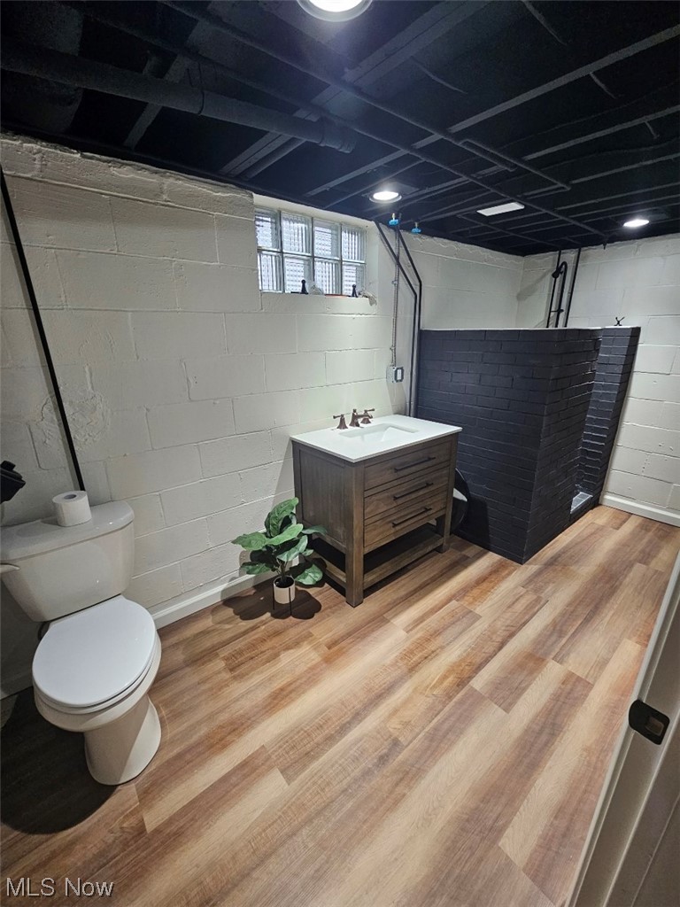3439 Surrey Road Southeast Warren, OH 44484 - Photo 20 of 32 Lower level bathroom featuring light wood-type flooring, new toilet vanity, and refinished enclosed shower