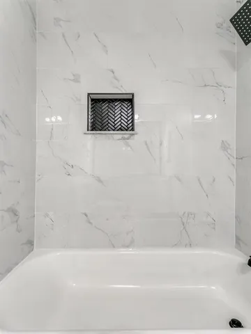 a bathroom with a bathtub and a shower