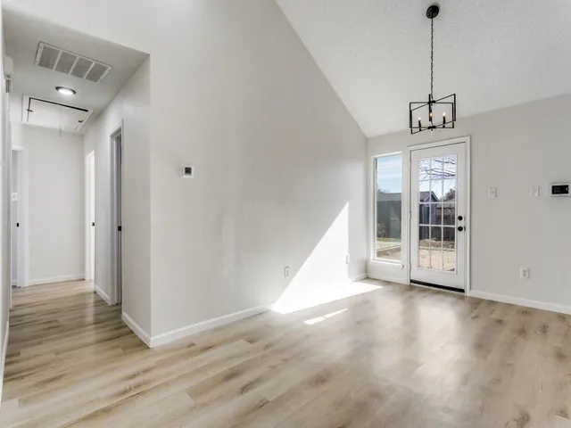 a view of a room with wooden floor and windows
