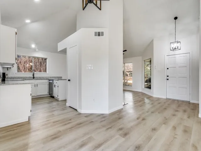 a view of a kitchen with wooden floor