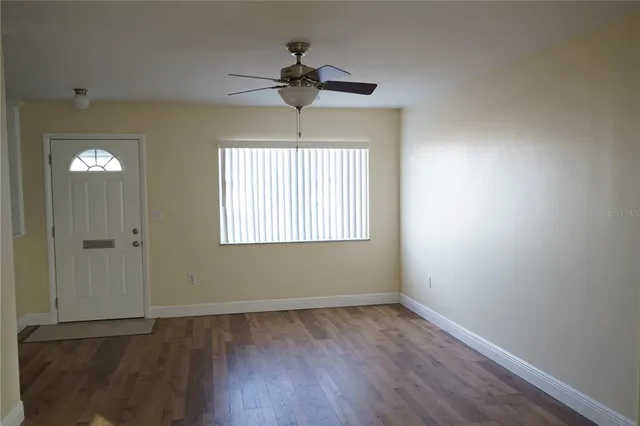 wooden floor in an empty room with a window
