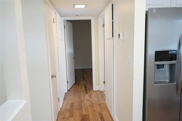 a view of a hallway with a wooden floor