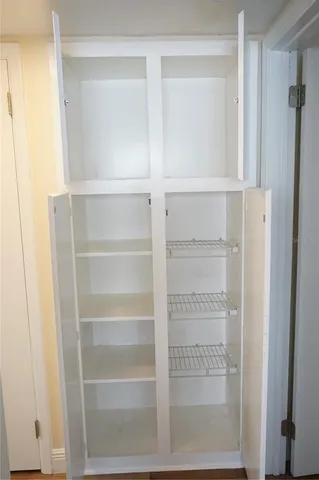 a view of walk in closet with empty racks