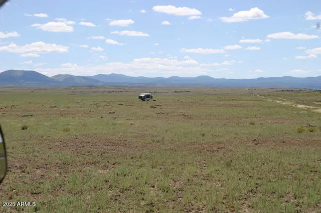 a view of an ocean beach and mountain