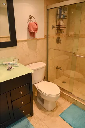 a bathroom with a sink a toilet and shower