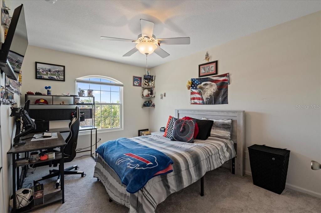 3271 Titanic Circle, Unit 39 Indialantic, FL 32903 - Photo 26 of 60 a bedroom with a bed and a chandelier