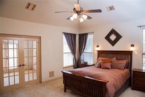 4122 West Crescent Way Frisco, TX 75034 - Photo 7 of 20 a bedroom with a bed chandelier and a window