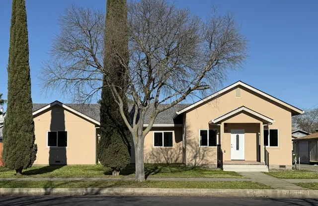 a front view of a house with a yard