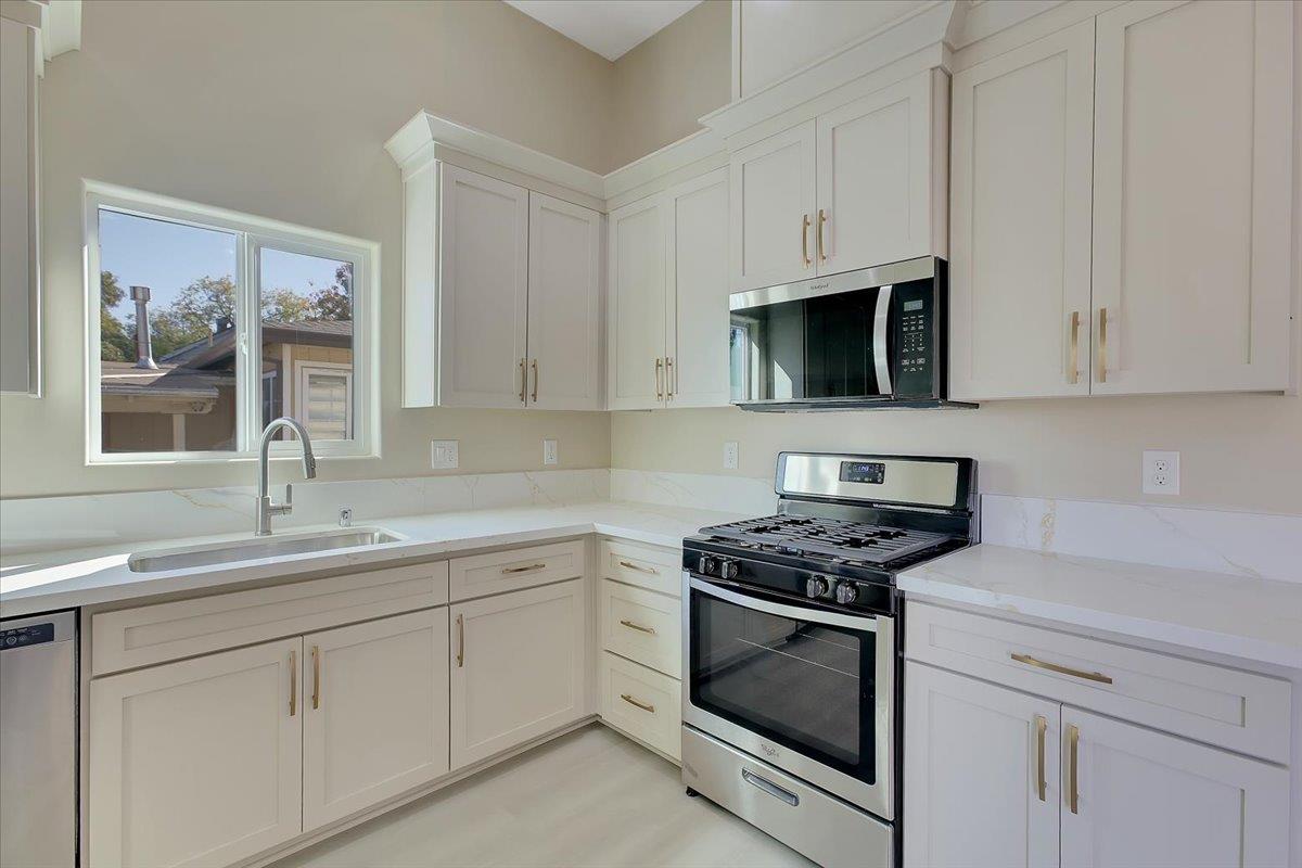 130 Fremont Street Colusa, CA 95932 - Photo 13 of 39 a kitchen with white cabinets and white appliances