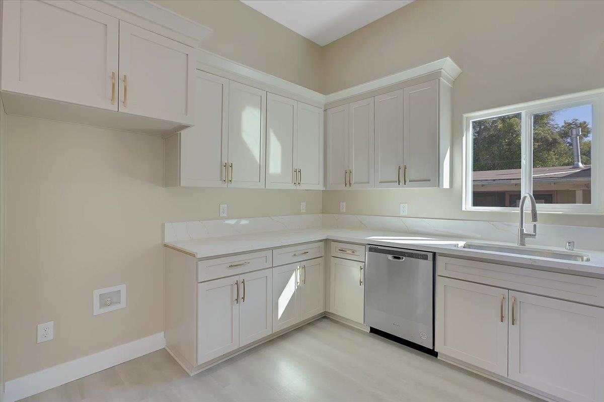 130 Fremont Street Colusa, CA 95932 - Photo 14 of 39 a kitchen with white cabinets and a sink
