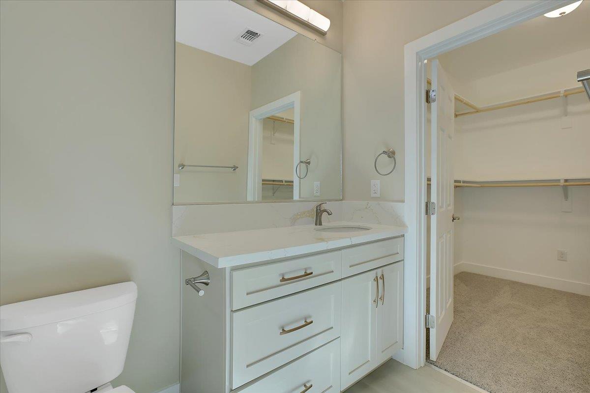 130 Fremont Street Colusa, CA 95932 - Photo 26 of 39 a bathroom with a granite countertop sink a toilet and a mirror
