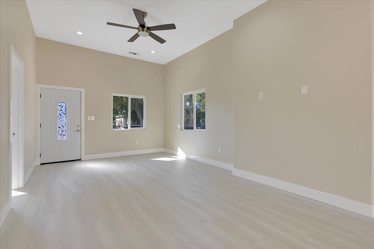 130 Fremont Street Colusa, CA 95932 - Photo 3 of 39 an empty room with chandelier fan and windows