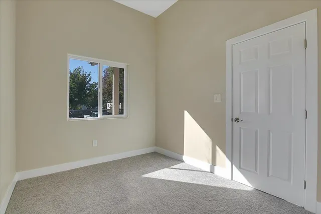 an entryway to ceiling window and stairs