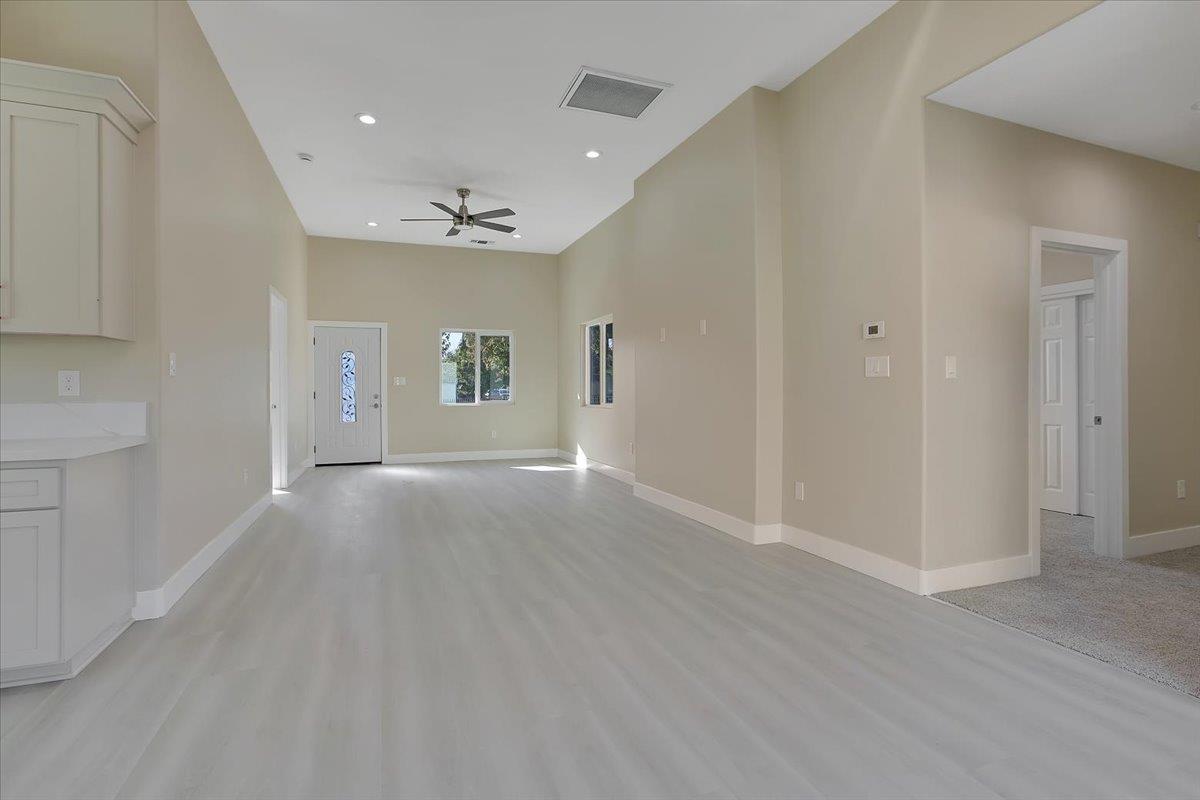 130 Fremont Street Colusa, CA 95932 - Photo 7 of 39 an empty room with wooden floor and windows