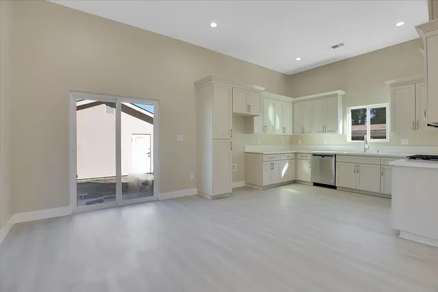 a view of a kitchen with a sink and a window