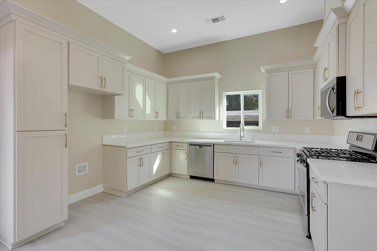 130 Fremont Street Colusa, CA 95932 - Photo 10 of 39 a kitchen with granite countertop cabinets stainless steel appliances and a sink