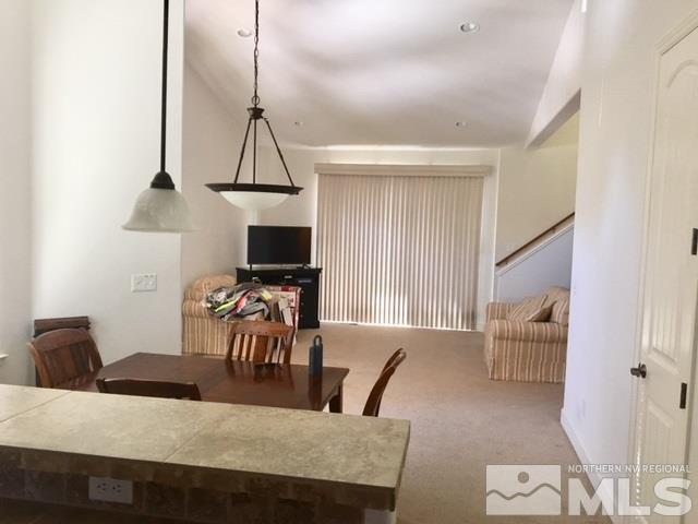 3677 A Warren Way Reno, NV 89509 - Photo 4 of 10 a view of a dining room with furniture a chandelier and wooden floor